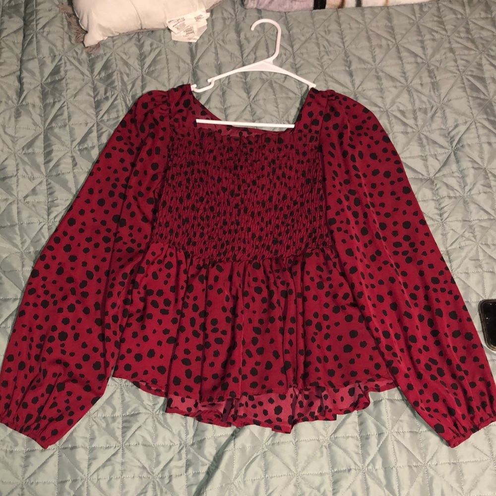 Burgundy long sleeve blouse with polka dots.